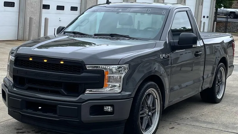 Gray Ford F-150 regular cab outside the shop